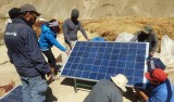 Team positions solar panel, one of 3 used for the 7 houses